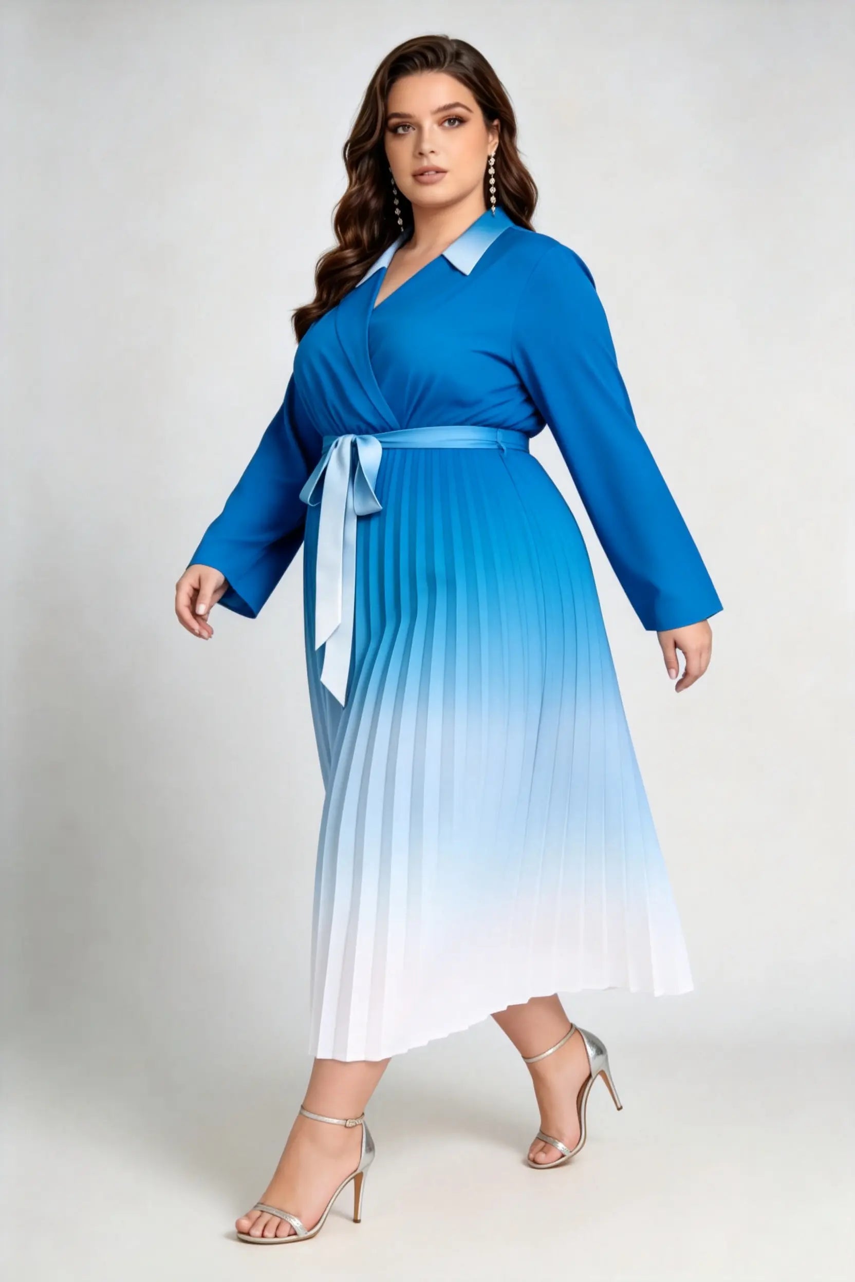 Curvy model wearing plus size blue gradient pleated midi dress, lapel collar wrap v-neck long sleeve belted a-line work dress