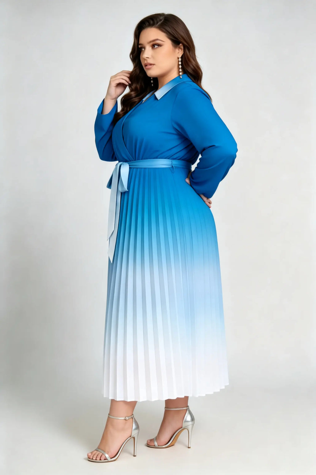 Curvy model wearing plus size blue gradient pleated midi dress, lapel collar wrap v-neck long sleeve belted a-line work dress
