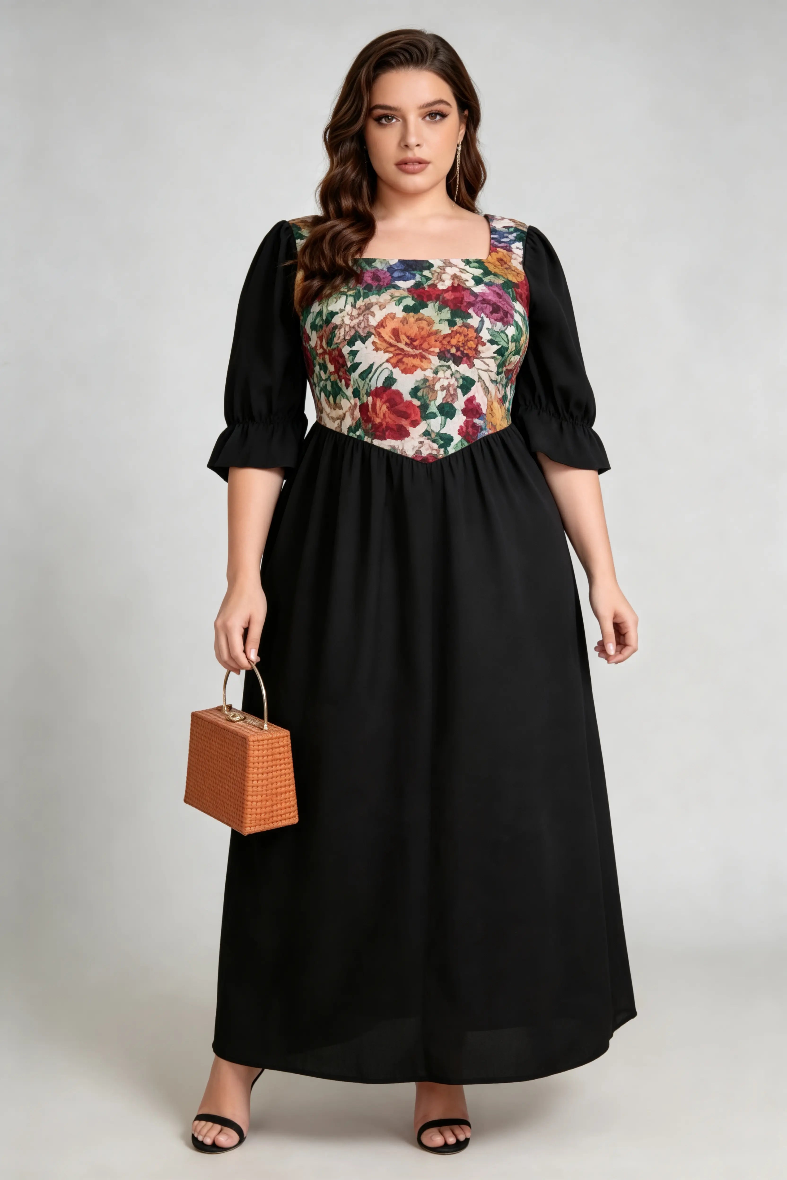 Curvy model wearing plus size floral print square neck maxi dress, black a-line with puffed sleeves, elegant summer dress