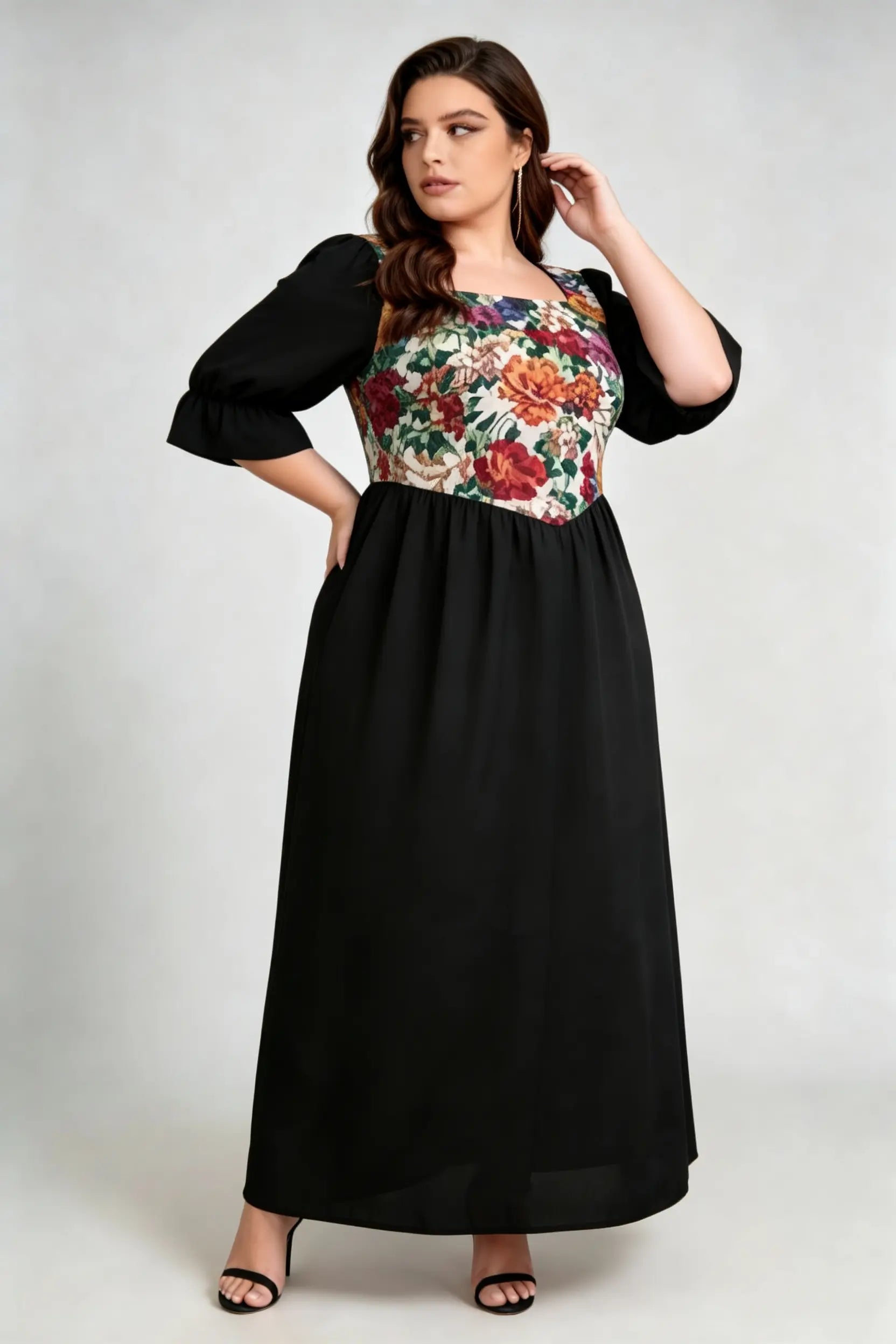 Curvy model wearing plus size floral print square neck maxi dress, black a-line with puffed sleeves, elegant summer dress