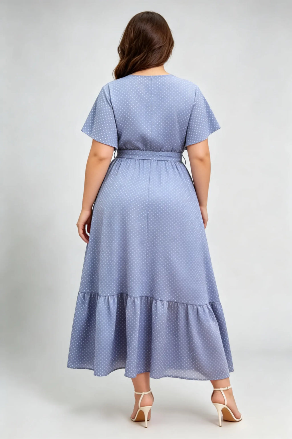 Curvy model wearing plus size blue polka dot wrap maxi dress, v-neck flutter sleeve a-line with belt, elegant summer dress