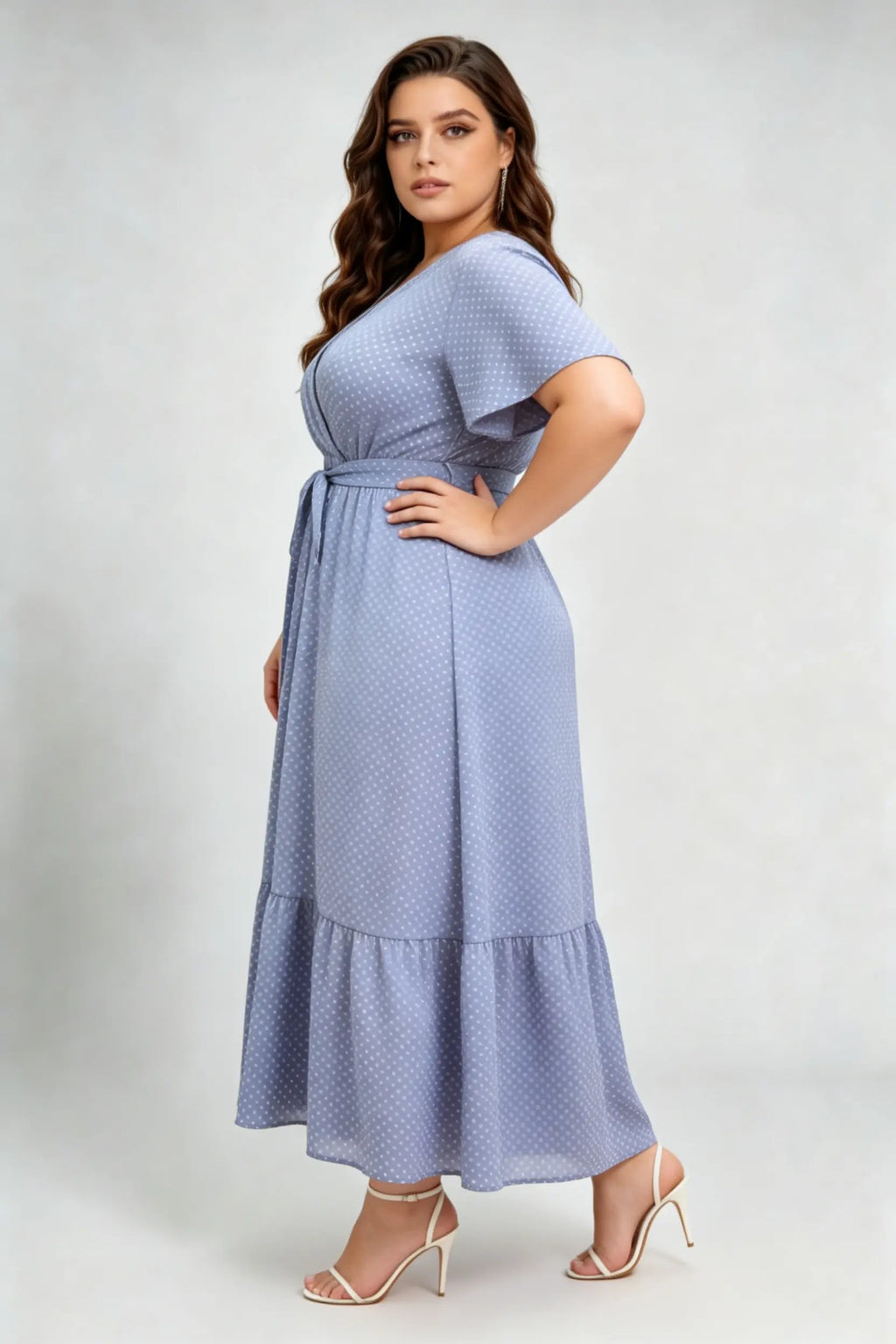 Curvy model wearing plus size blue polka dot wrap maxi dress, v-neck flutter sleeve a-line with belt, elegant summer dress