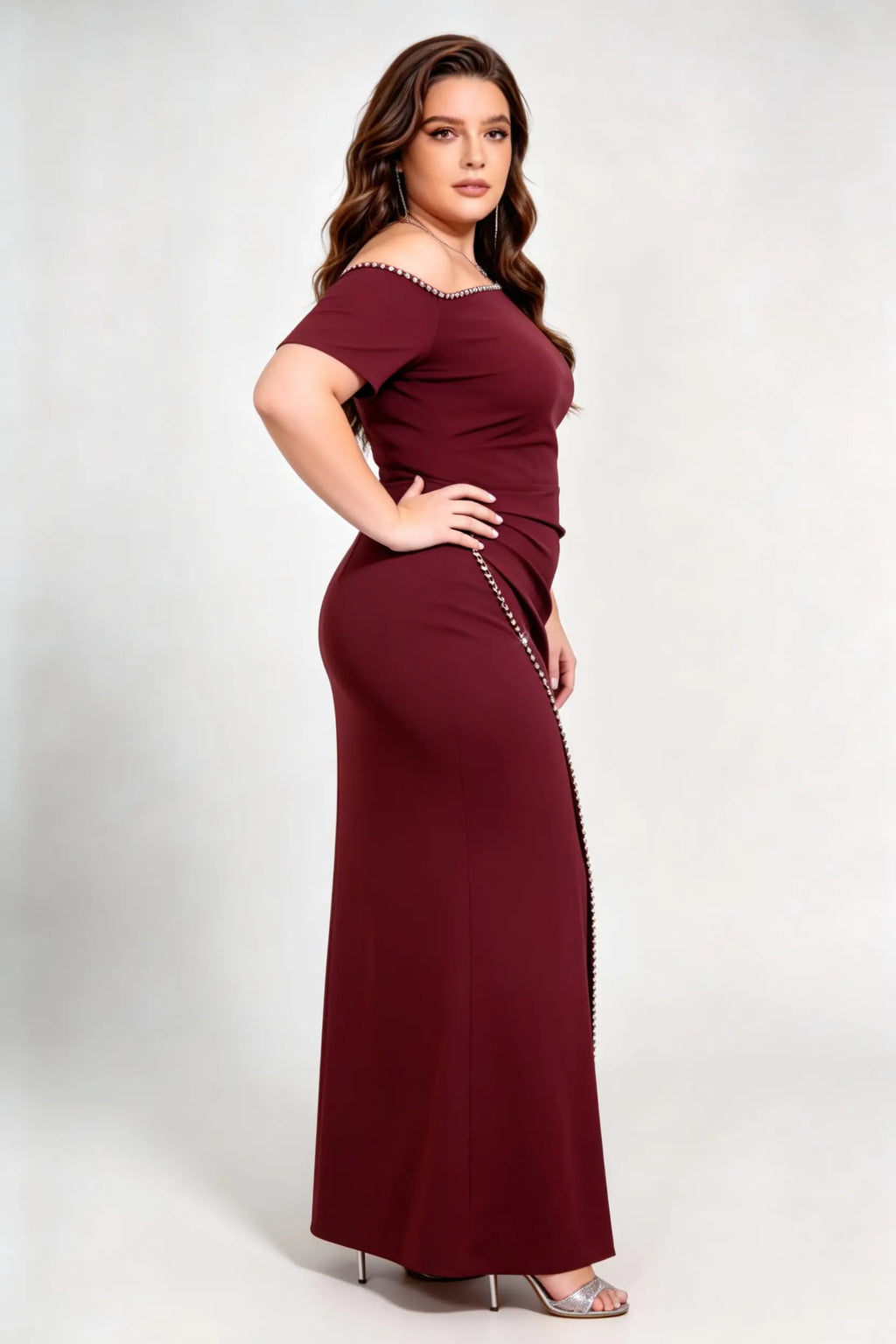 Curvy model wearing plus size rose-red burgundy rhinestone trim evening gown, square neck/off-shoulder mermaid maxi dress with slit