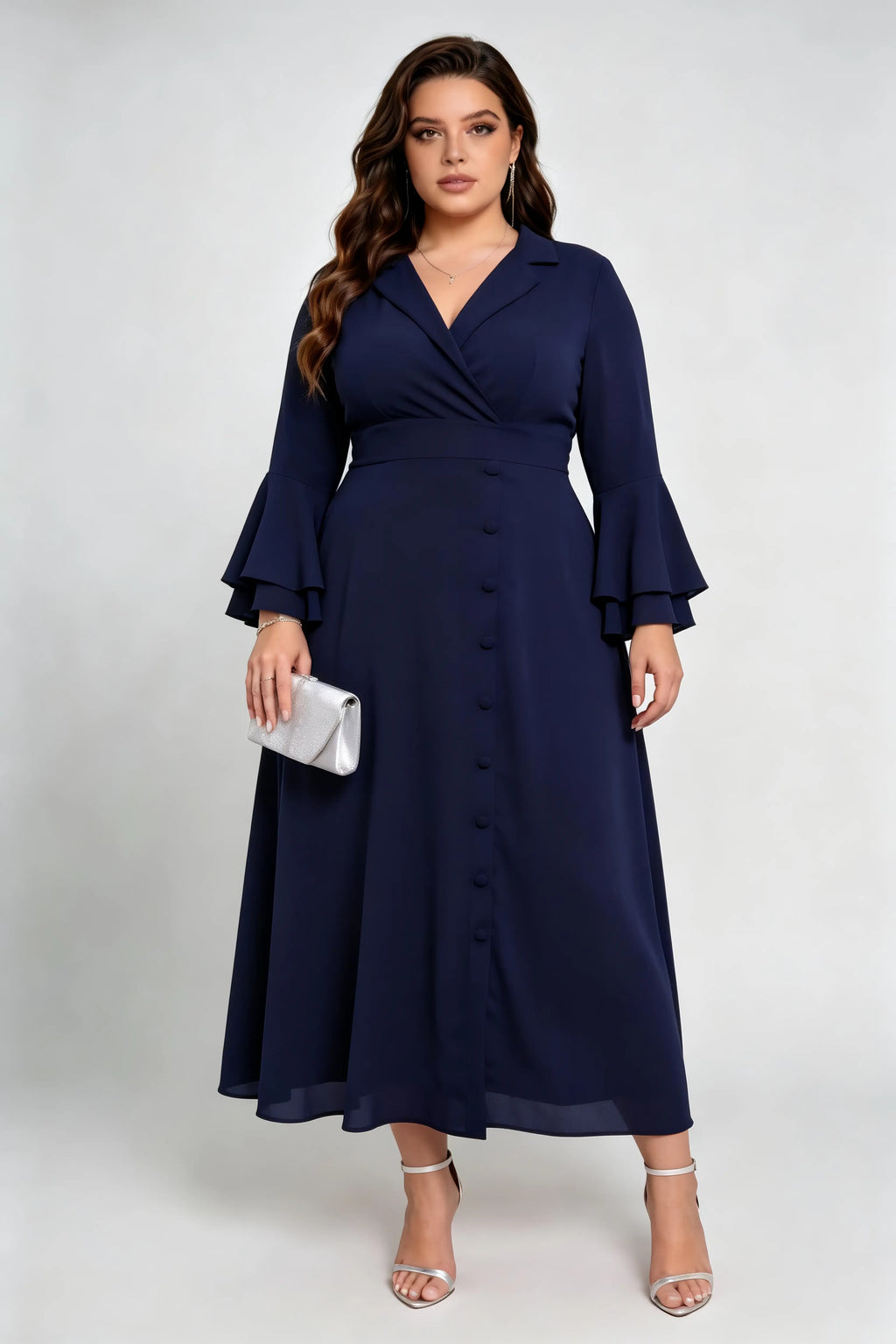 Curvy model wearing plus size navy blue wrap midi dress, notched lapel blazer style with flounce sleeves and waist tie