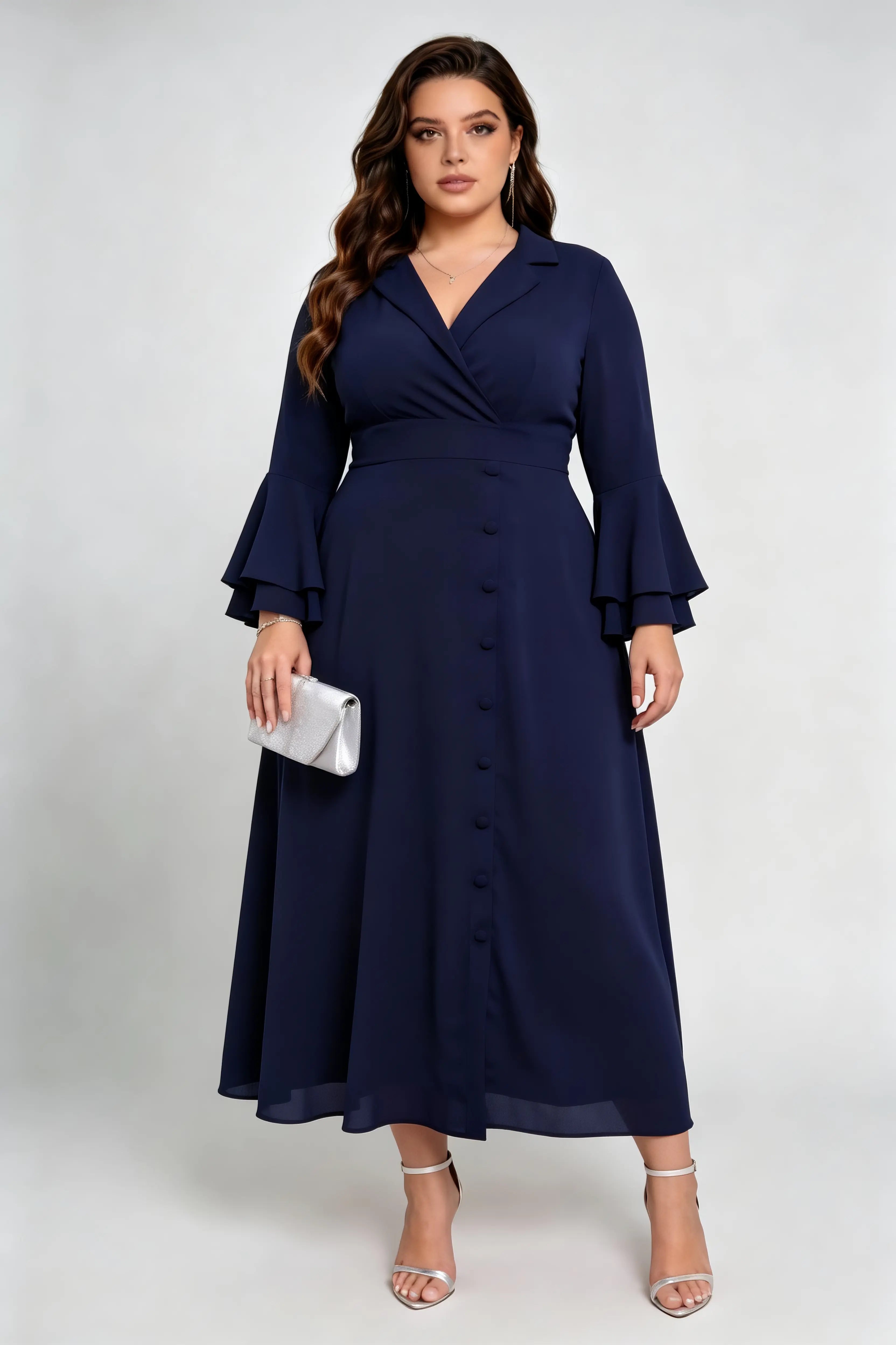 Curvy model wearing plus size navy blue wrap midi dress, notched lapel blazer style with flounce sleeves and waist tie