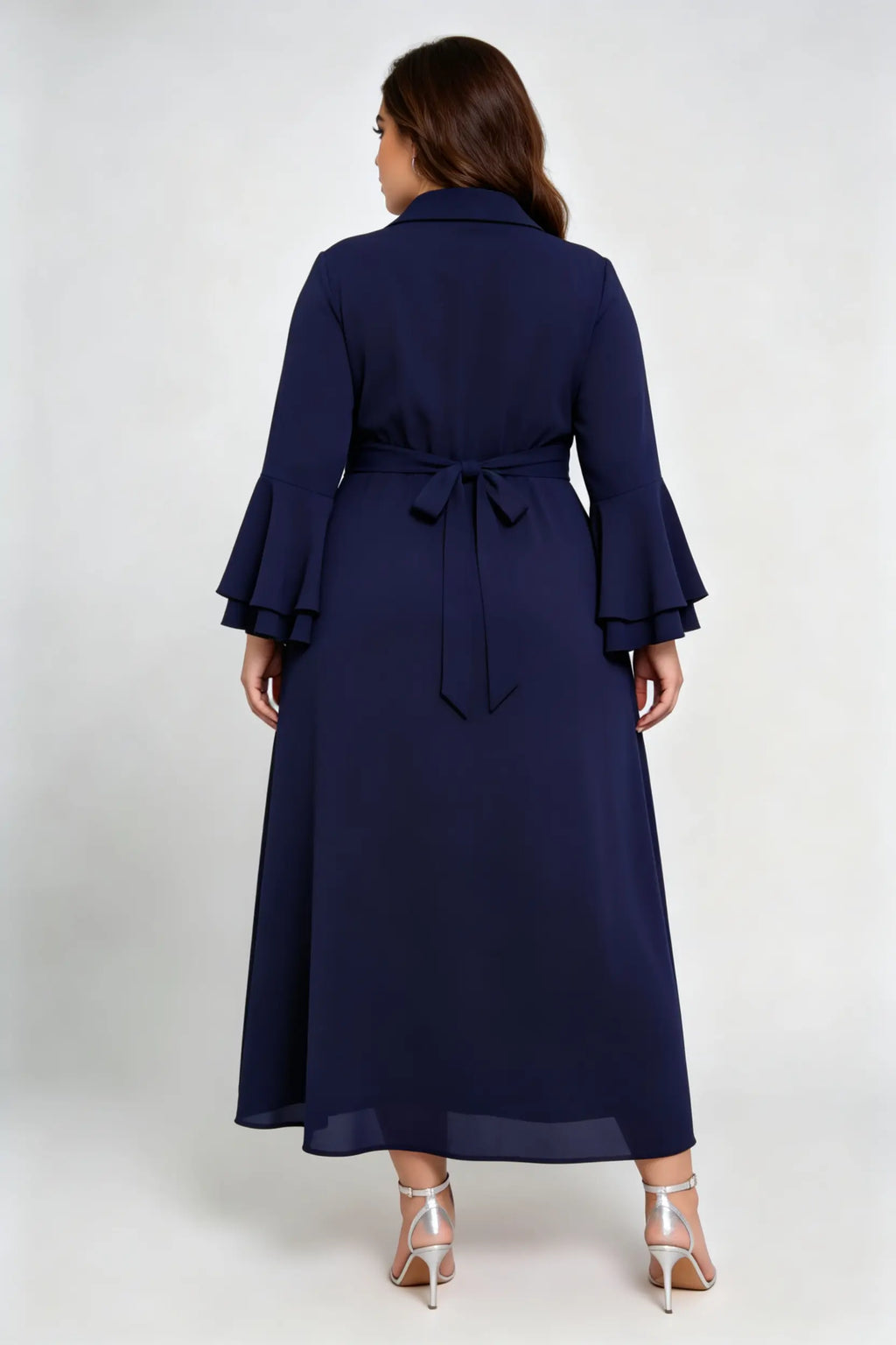 Curvy model wearing plus size navy blue wrap midi dress, notched lapel blazer style with flounce sleeves and waist tie