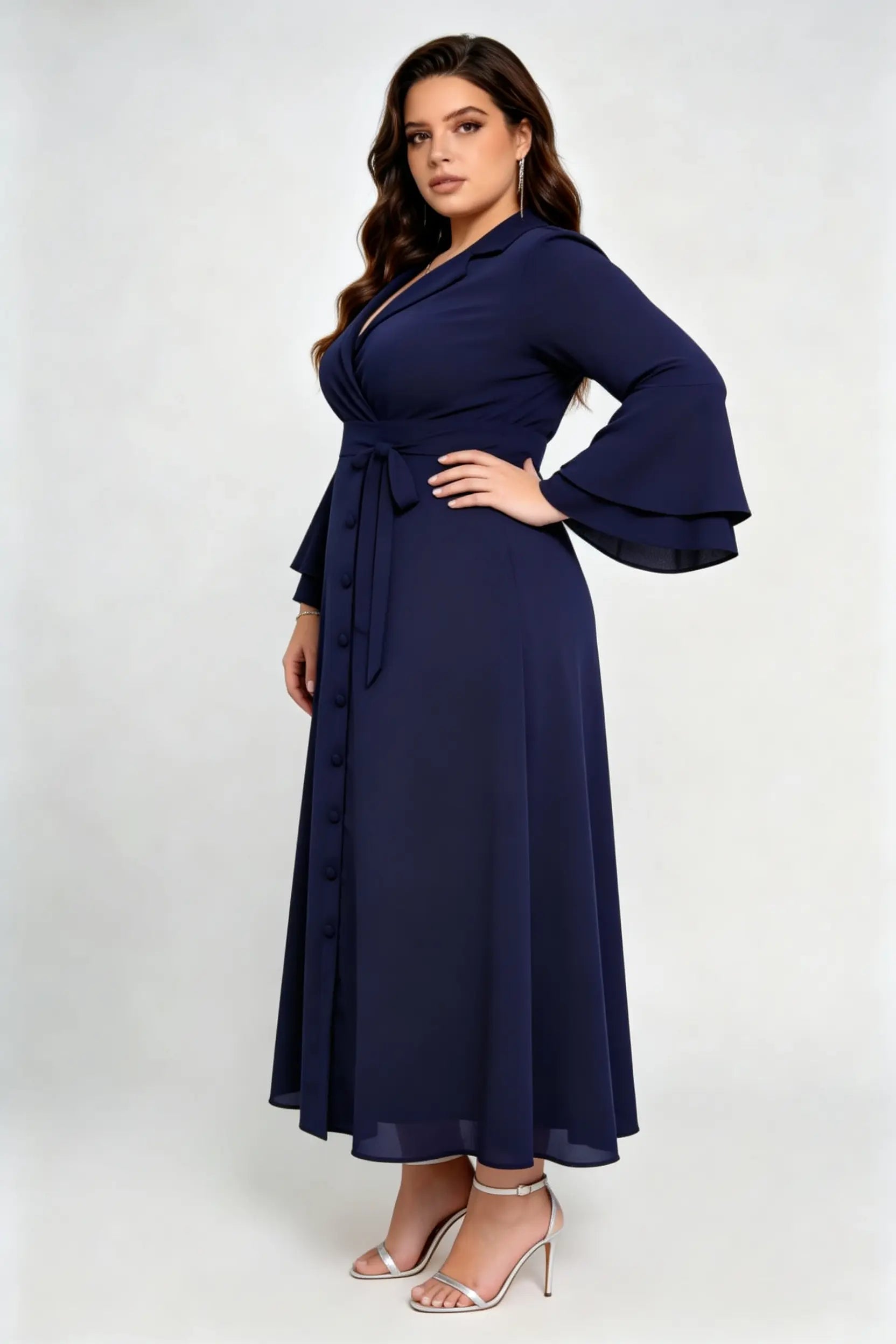 Curvy model wearing plus size navy blue wrap midi dress, notched lapel blazer style with flounce sleeves and waist tie