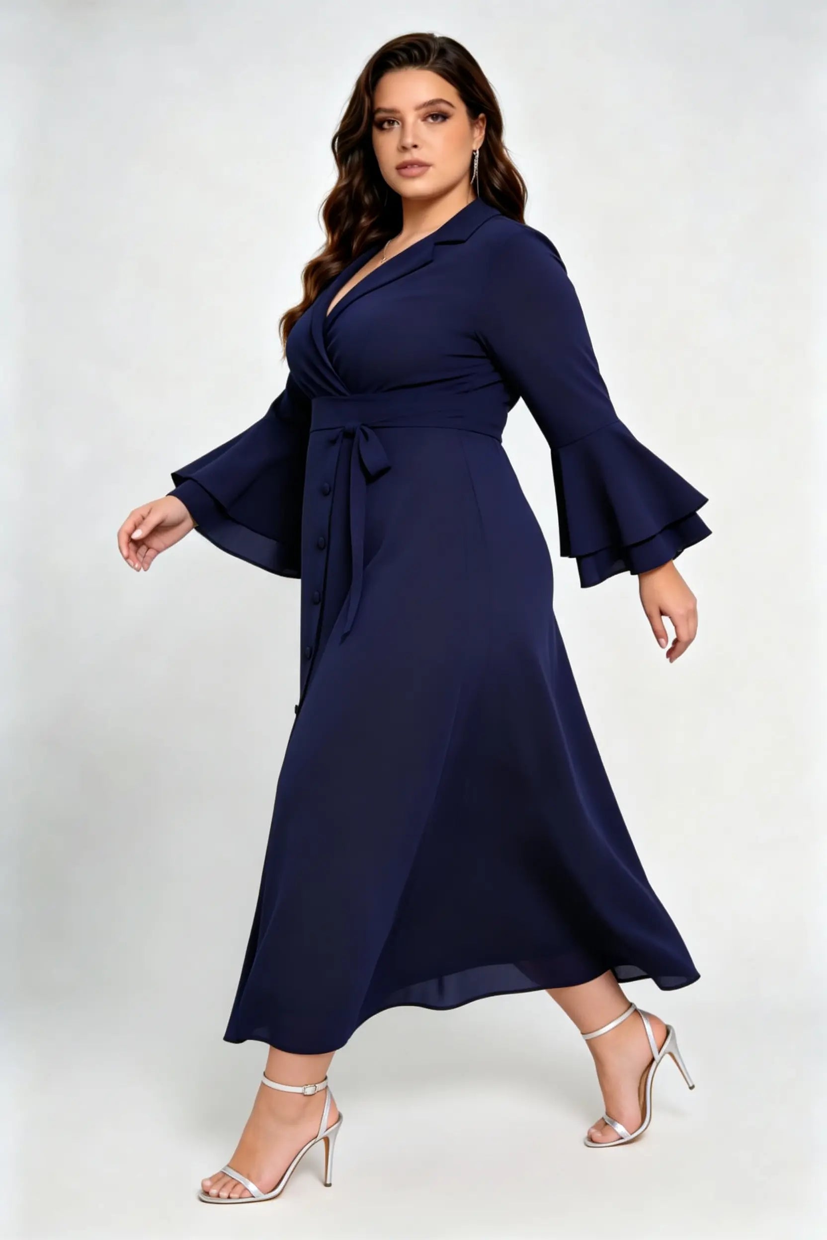 Curvy model wearing plus size navy blue wrap midi dress, notched lapel blazer style with flounce sleeves and waist tie