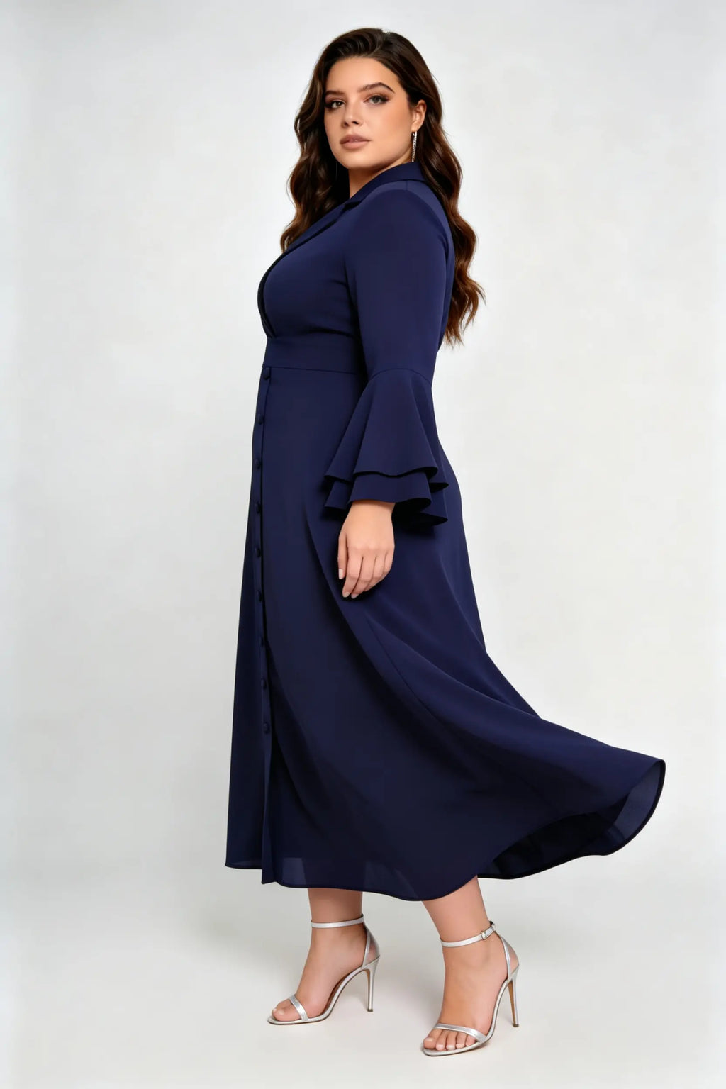 Curvy model wearing plus size navy blue wrap midi dress, notched lapel blazer style with flounce sleeves and waist tie