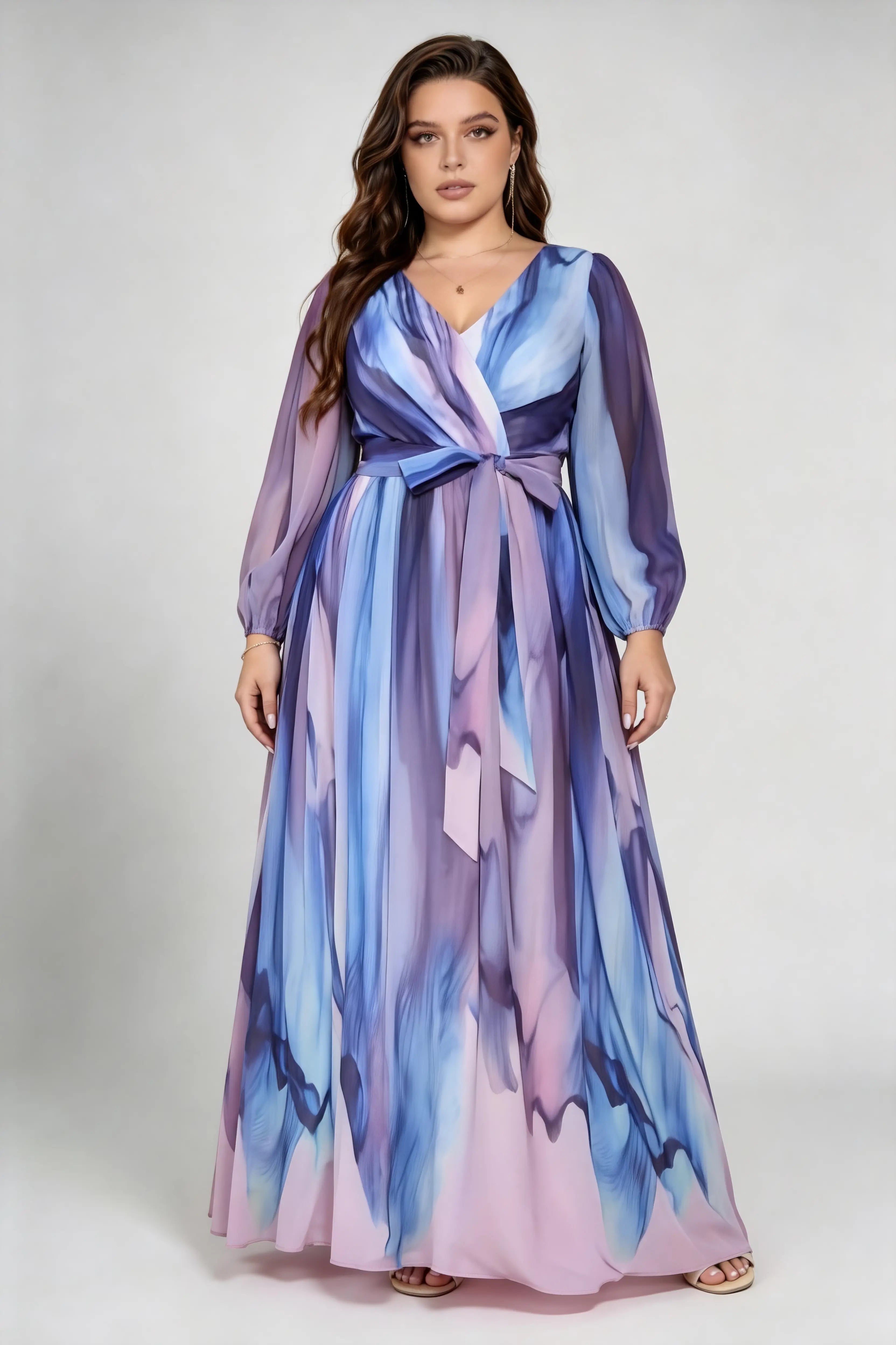 Curvy model wearing plus size floral deep v neck watercolor print chiffon belted bishop sleeve a line maxi formal evening dress
