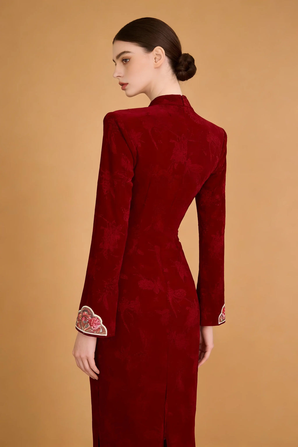 Woman wearing a Red Floral Embroidered Qipao Dress on a brown background