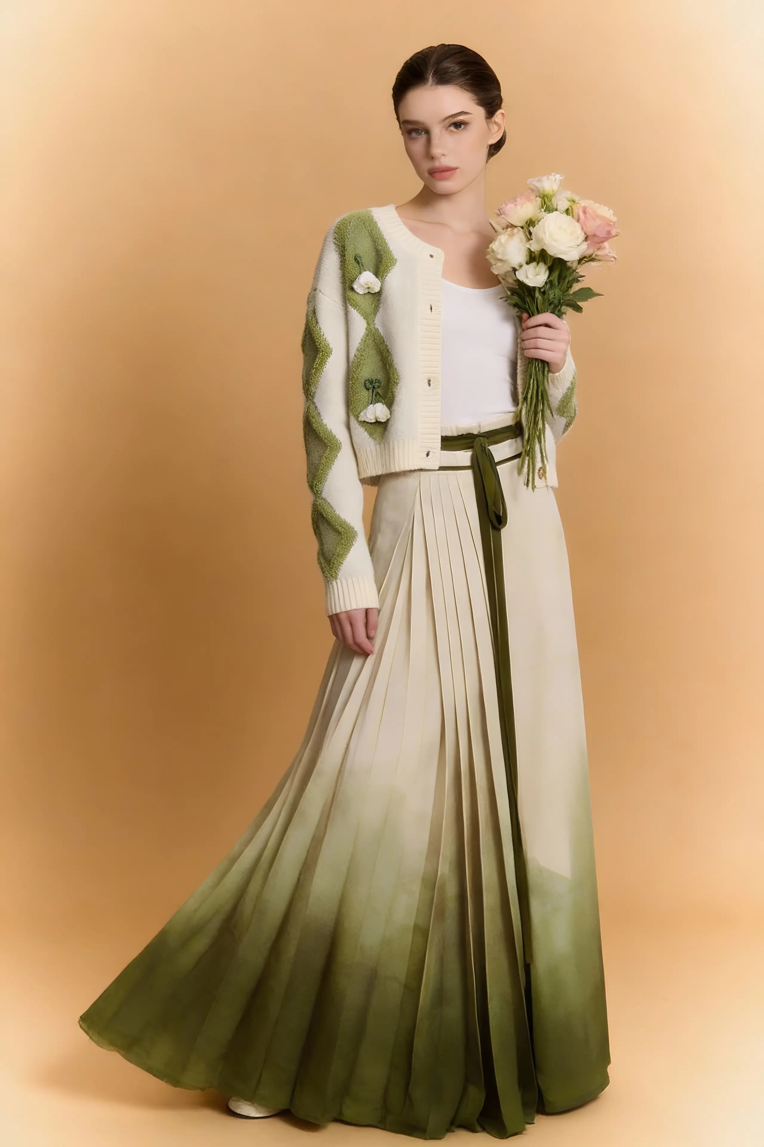 Woman wearing a Green & White Argyle Knit Cardigan with Pleated Ombre Skirt Set on a beige background