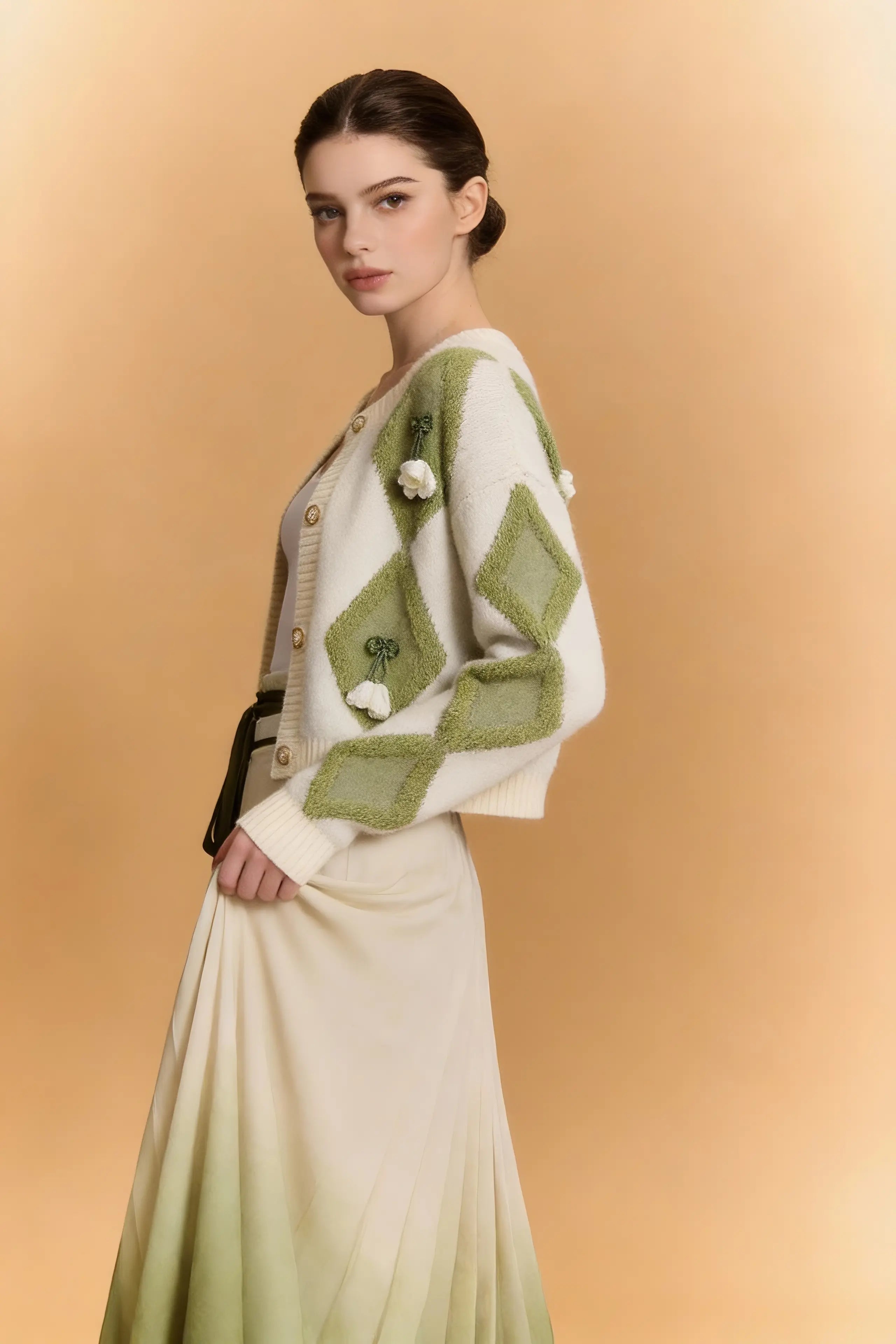 Woman wearing a Green & White Argyle Knit Cardigan with Pleated Ombre Skirt Set on a beige background