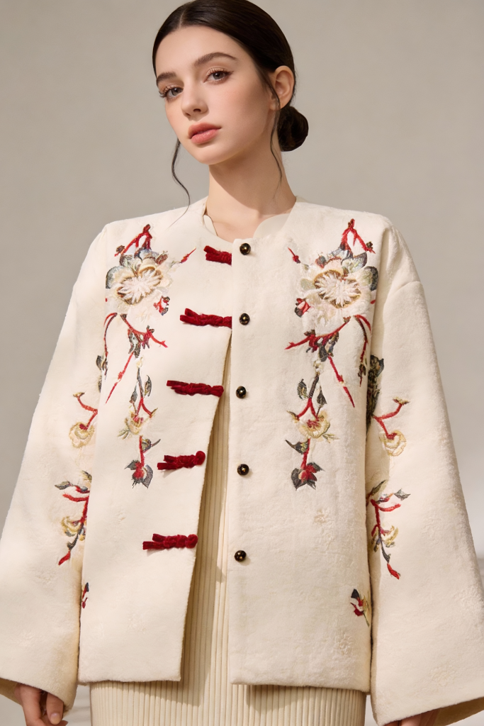 Woman wearing a cream-colored Embroidered Wool Blend Jacket with Floral Patterns & Frog Buttons on a neutral background