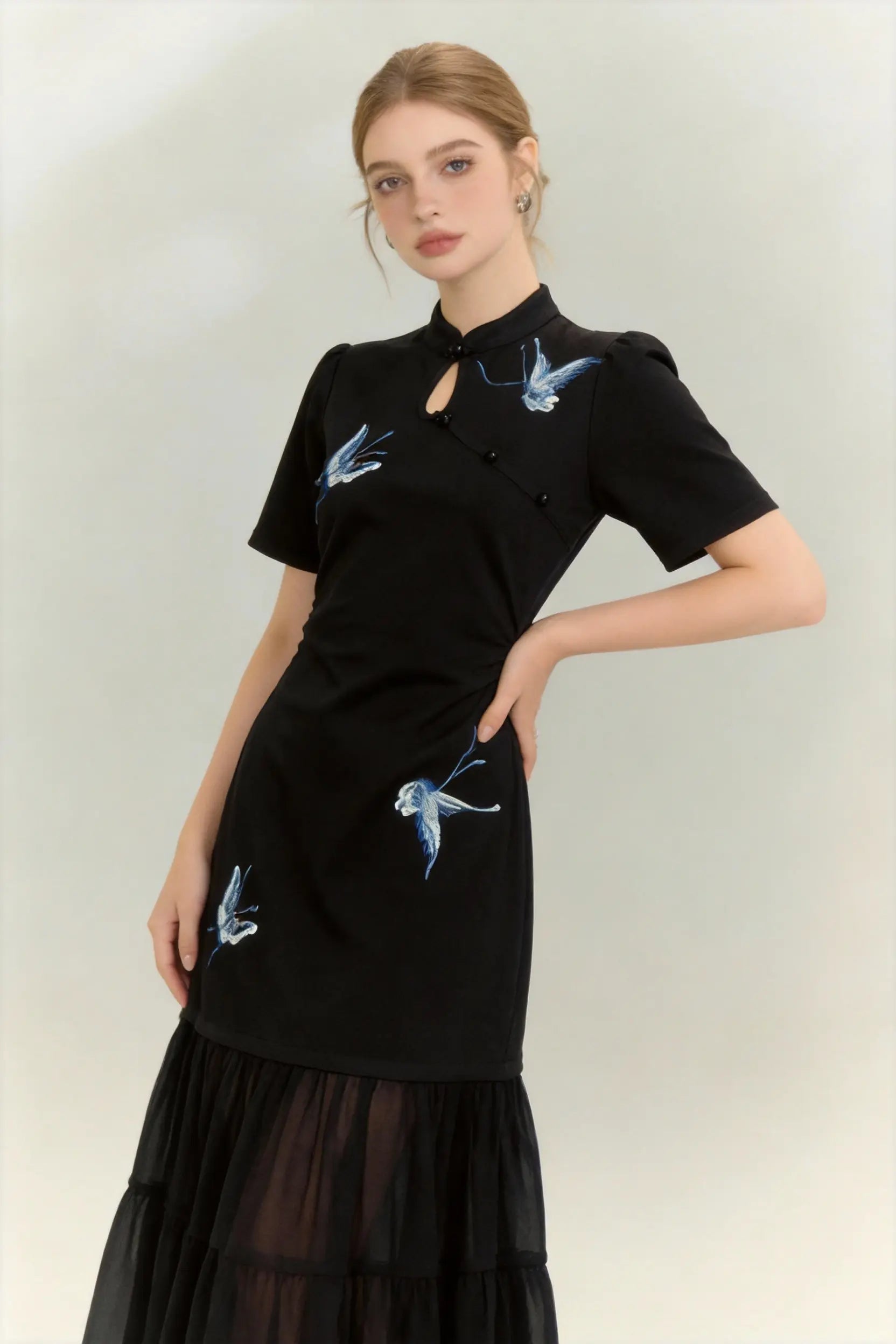 Woman wearing a Traditional Chinese Qipao Dress with Blue Butterfly Embroidery - Elegant Oriental Maxi Dress on a light background
