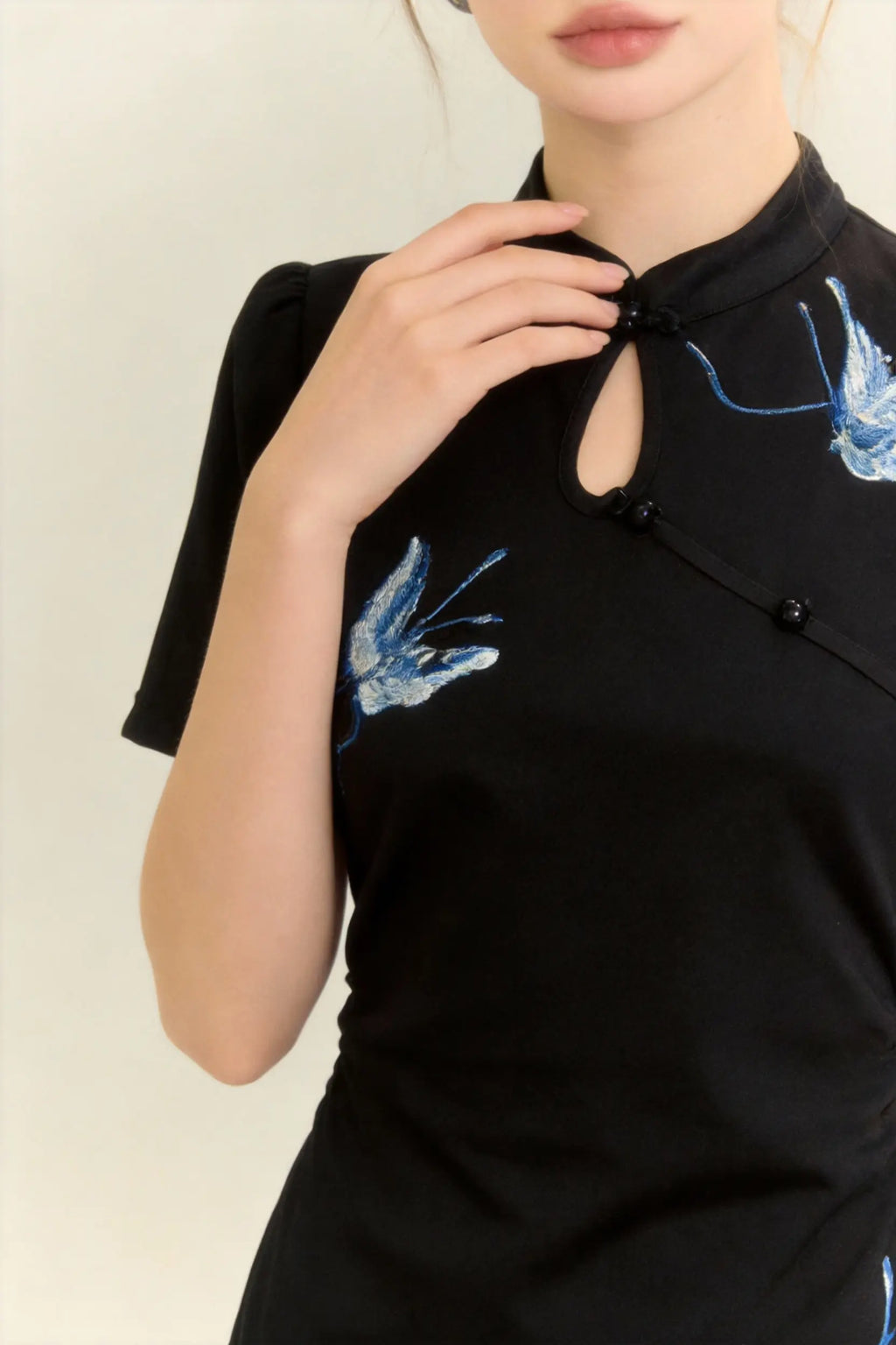 Woman wearing a Traditional Chinese Qipao Dress with Blue Butterfly Embroidery - Elegant Oriental Maxi Dress on a light background