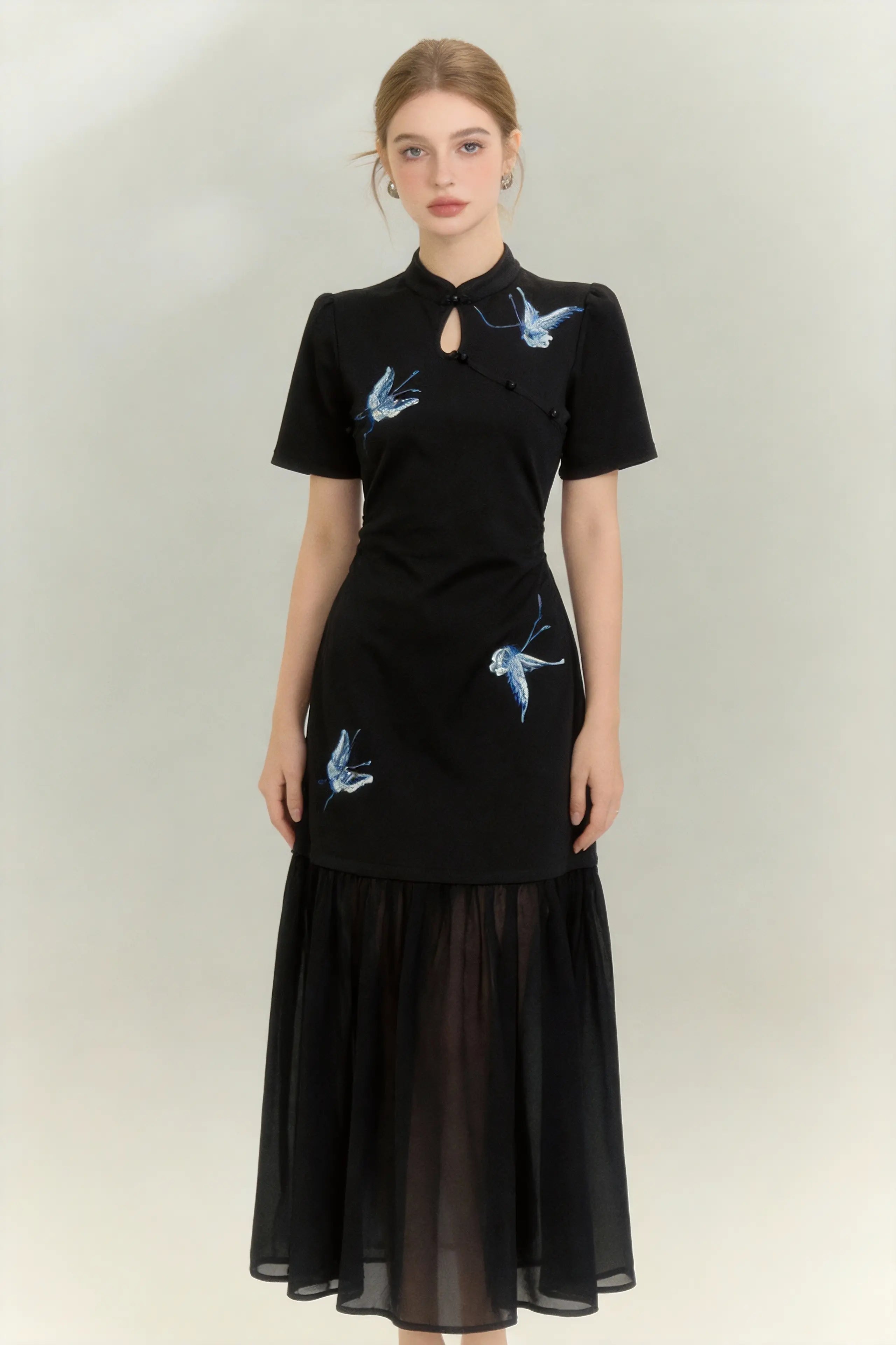 Woman wearing a Traditional Chinese Qipao Dress with Blue Butterfly Embroidery - Elegant Oriental Maxi Dress on a light background