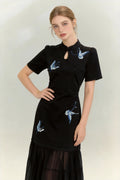 Woman wearing a Traditional Chinese Qipao Dress with Blue Butterfly Embroidery - Elegant Oriental Maxi Dress on a light background