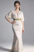 Woman wearing aElegant Floral Print Satin Evening Gown with Green Sash Belt on a gray background