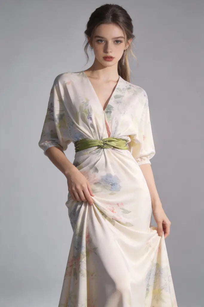 Woman wearing aElegant Floral Print Satin Evening Gown with Green Sash Belt on a gray background