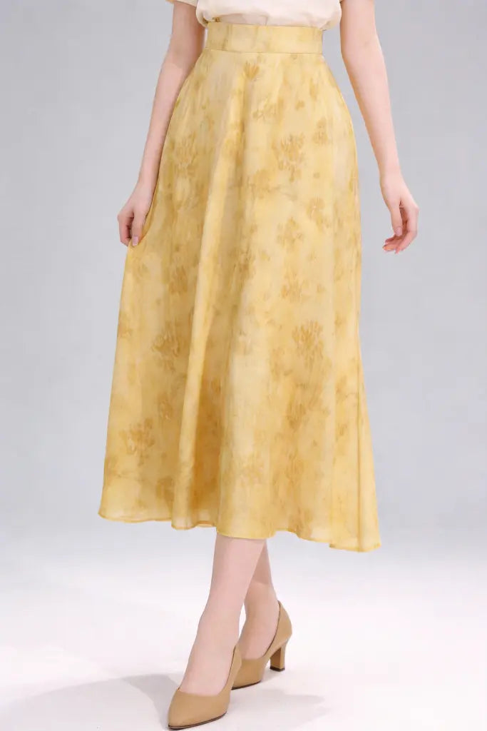 Yellow skirt worn by a person on a white background
