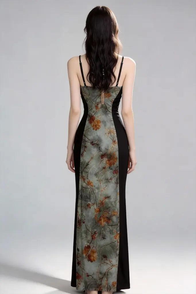 Woman wearing a floral dress with a black side panel on a gray background