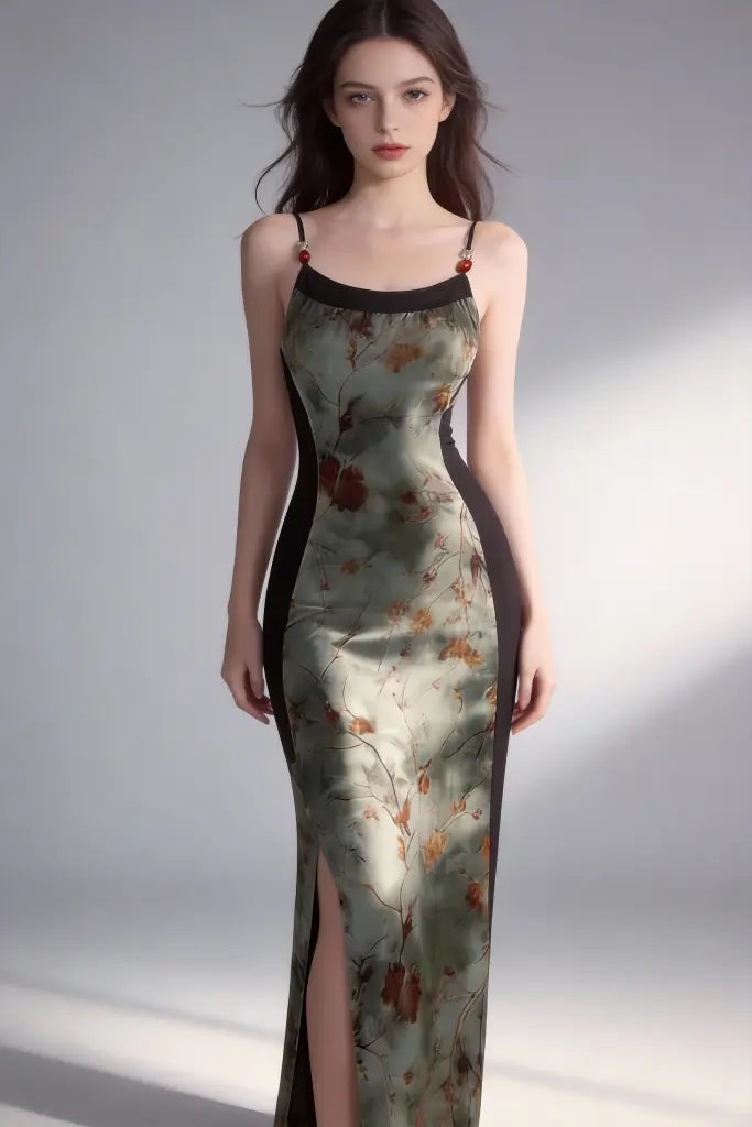 Woman wearing a floral dress with a high slit on a plain background