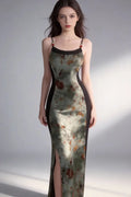 Woman wearing a floral dress with a high slit on a plain background