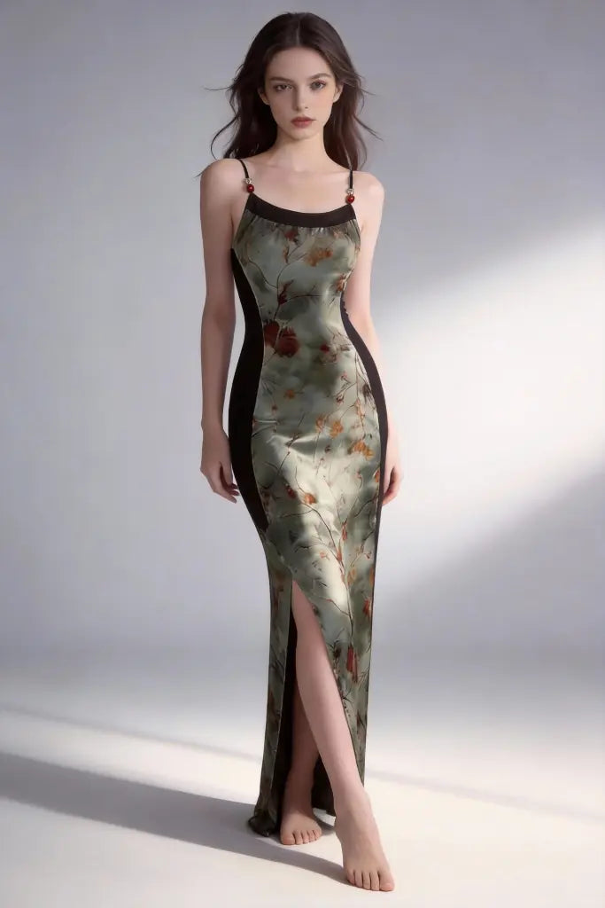 Woman wearing a floral dress with a high slit on a plain background
