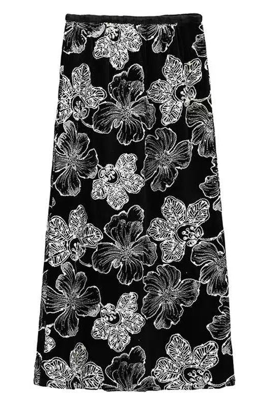 Black skirt with white floral pattern on a white background
