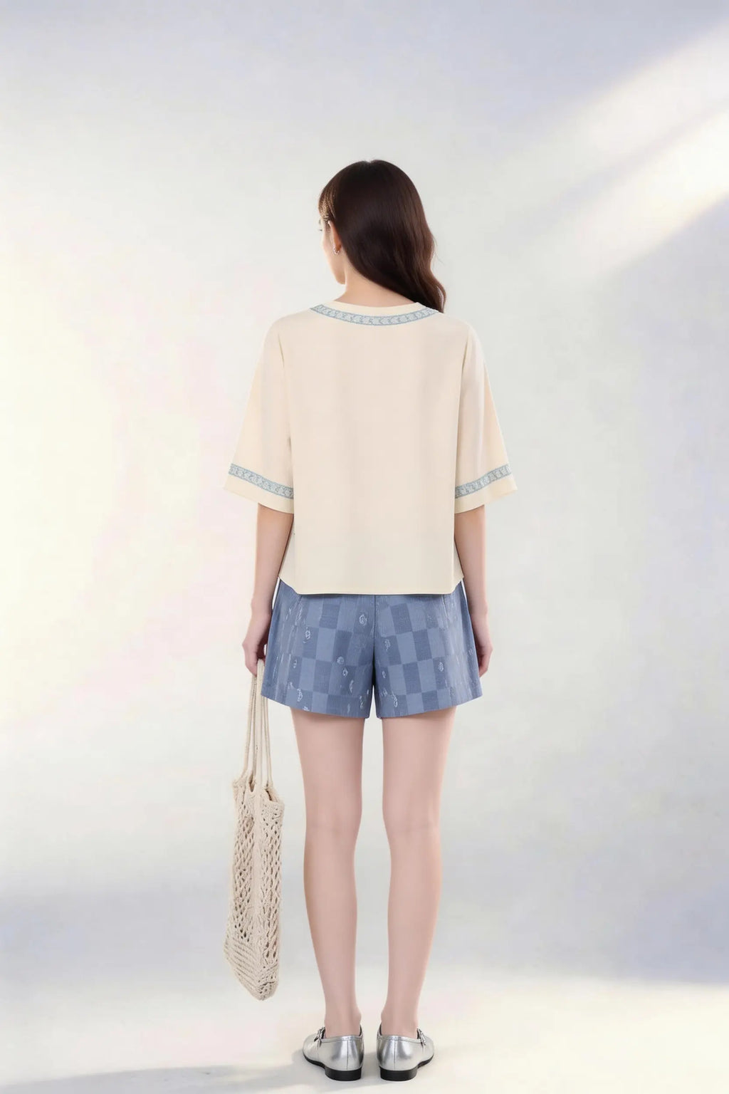 Woman wearing Vintage Floral Embroidered Top & Tie-Dye Shorts Two-Piece Set with a white background