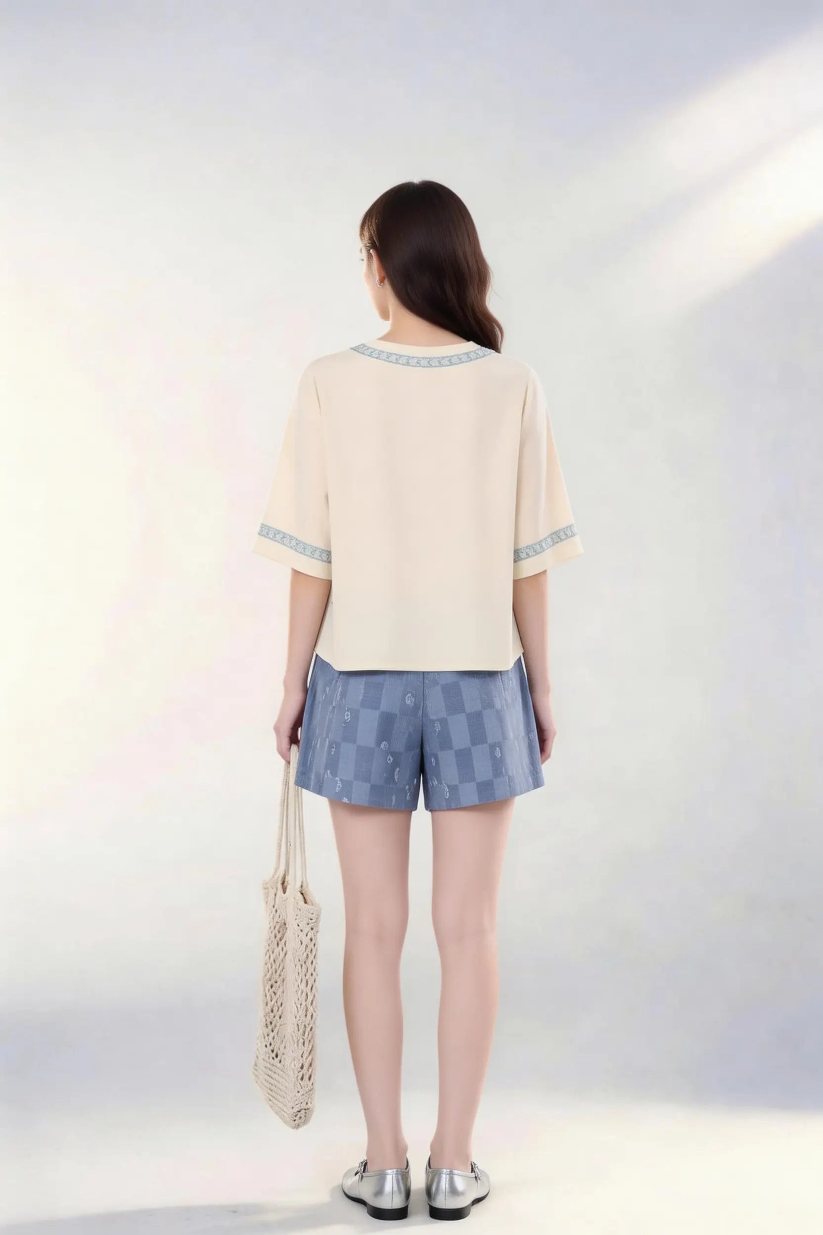 Woman wearing Vintage Floral Embroidered Top & Tie-Dye Shorts Two-Piece Set with a white background