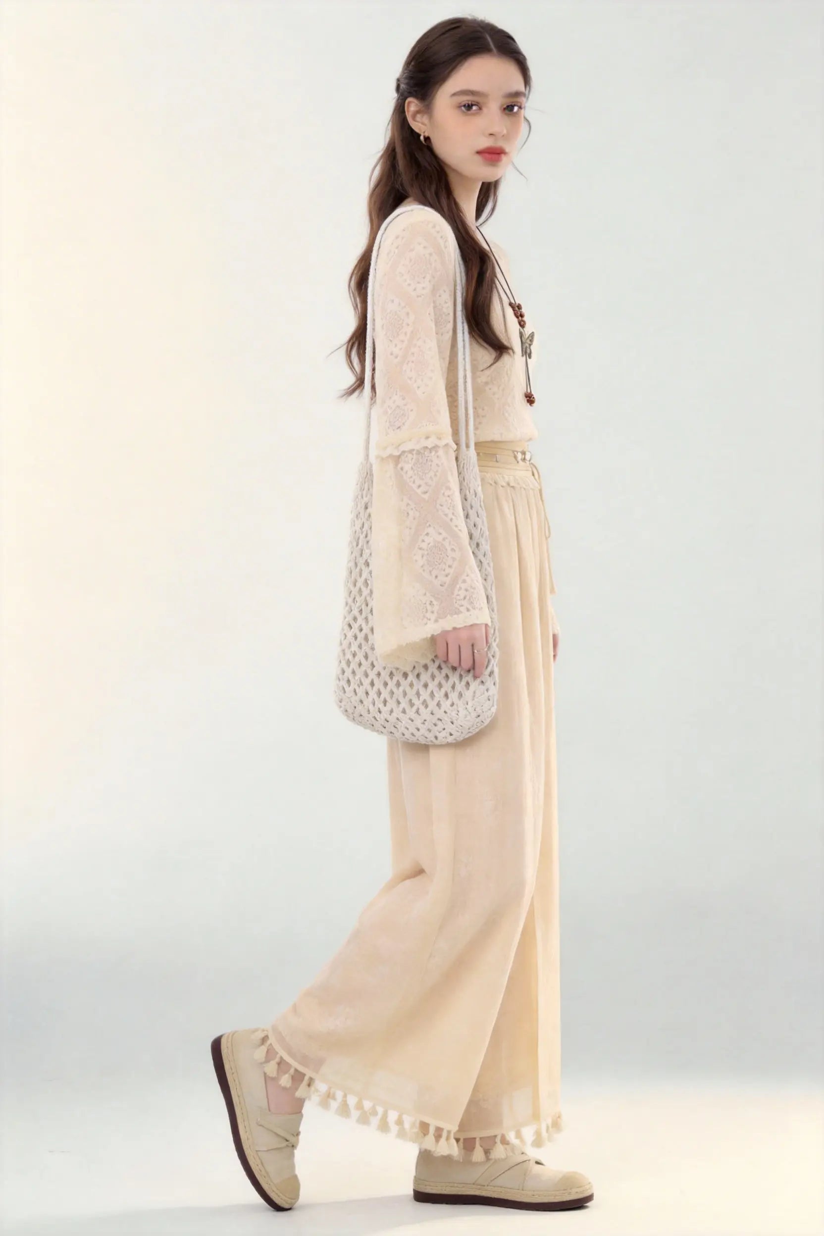 Woman in a beige Spring Summer New Ancient Style Hollow Lace Top High Waist Straight Wide Leg Pants Daily Versatile Two-Piece Set  against a white background