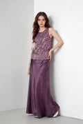 Woman wearing a purple Mauve Sequin Sleeveless Top & Satin Maxi Skirt Set against a white wall.
