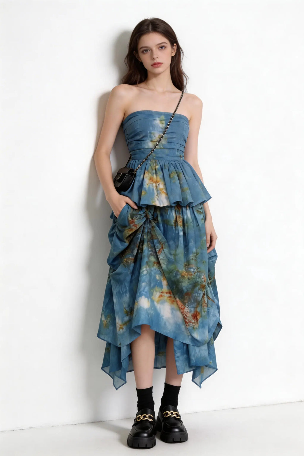 Woman wearing a Tie-Dye Blue Strapless Ruffle Top & Asymmetric Maxi Skirt Two-Piece Set with a plain background