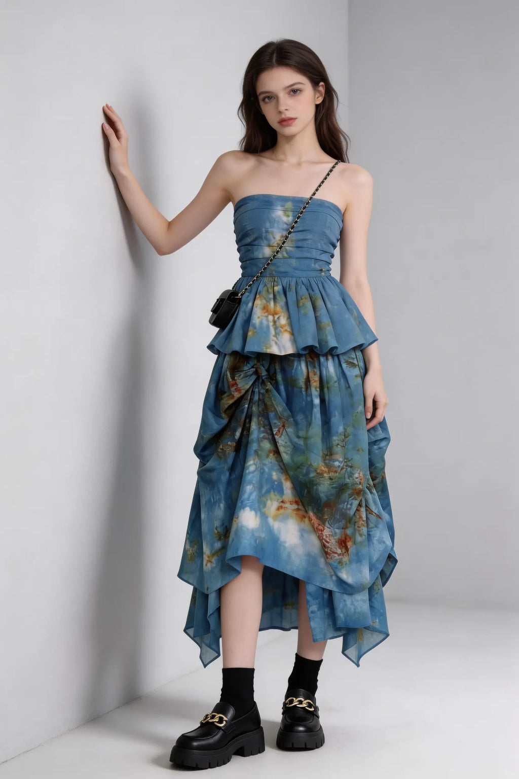 Woman wearing a Tie-Dye Blue Strapless Ruffle Top & Asymmetric Maxi Skirt Two-Piece Set with a plain background