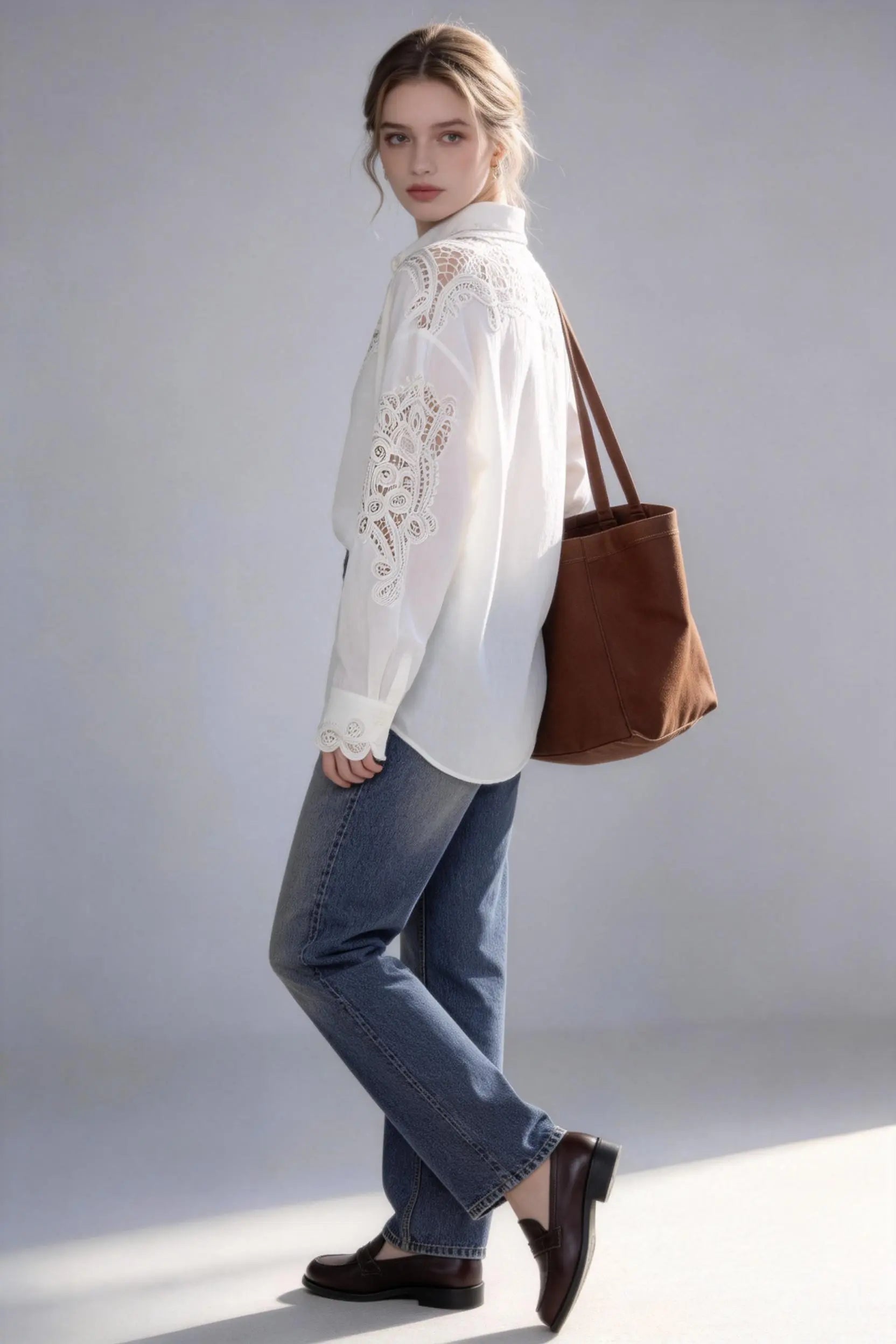 Woman wearing a white Vintage Lace-Trimmed Linen Blend Shirt - Elegant Long Sleeve Blouse, blue jeans, and carrying a brown bag on a plain background