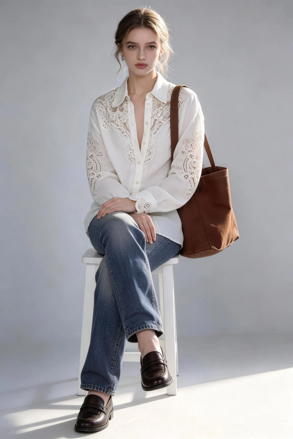 Woman wearing a white Vintage Lace-Trimmed Linen Blend Shirt - Elegant Long Sleeve Blouse, blue jeans, and carrying a brown bag on a plain background