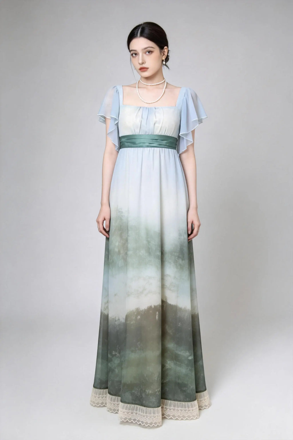 Woman wearing a green Vintage Ombr¨¦ Empire Waist Gown with Ruffled Sleeves and Back Bow on a gray background