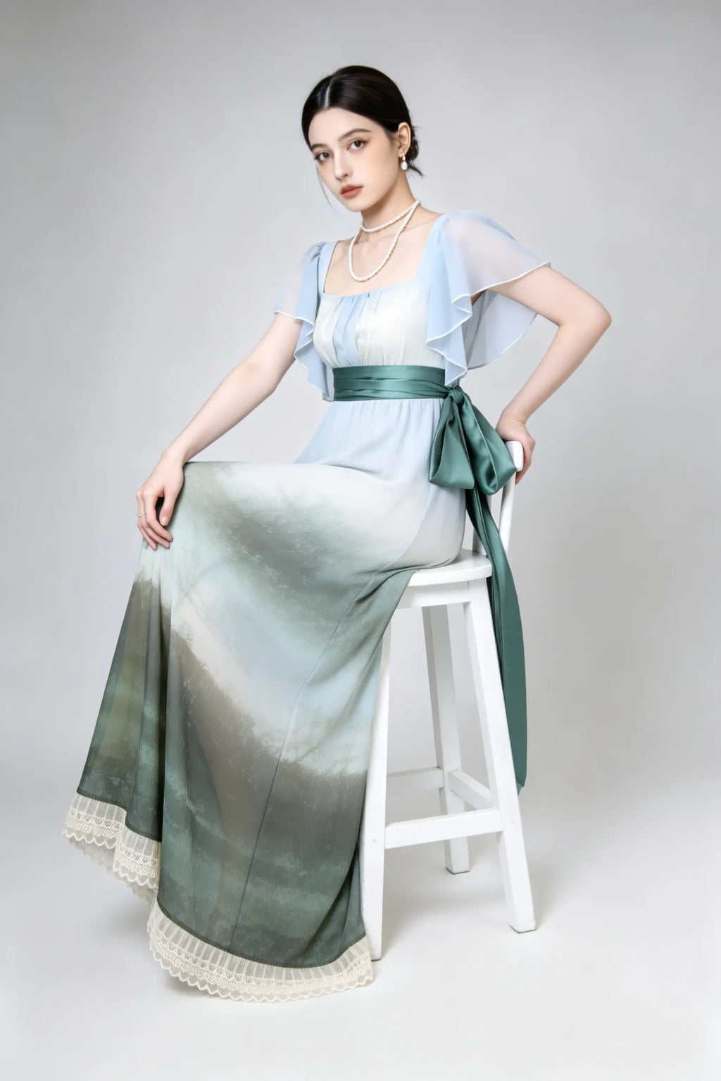 Woman wearing a green Vintage Ombr¨¦ Empire Waist Gown with Ruffled Sleeves and Back Bow on a gray background
