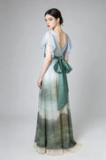 Woman wearing a green Vintage Ombr¨¦ Empire Waist Gown with Ruffled Sleeves and Back Bow on a gray background