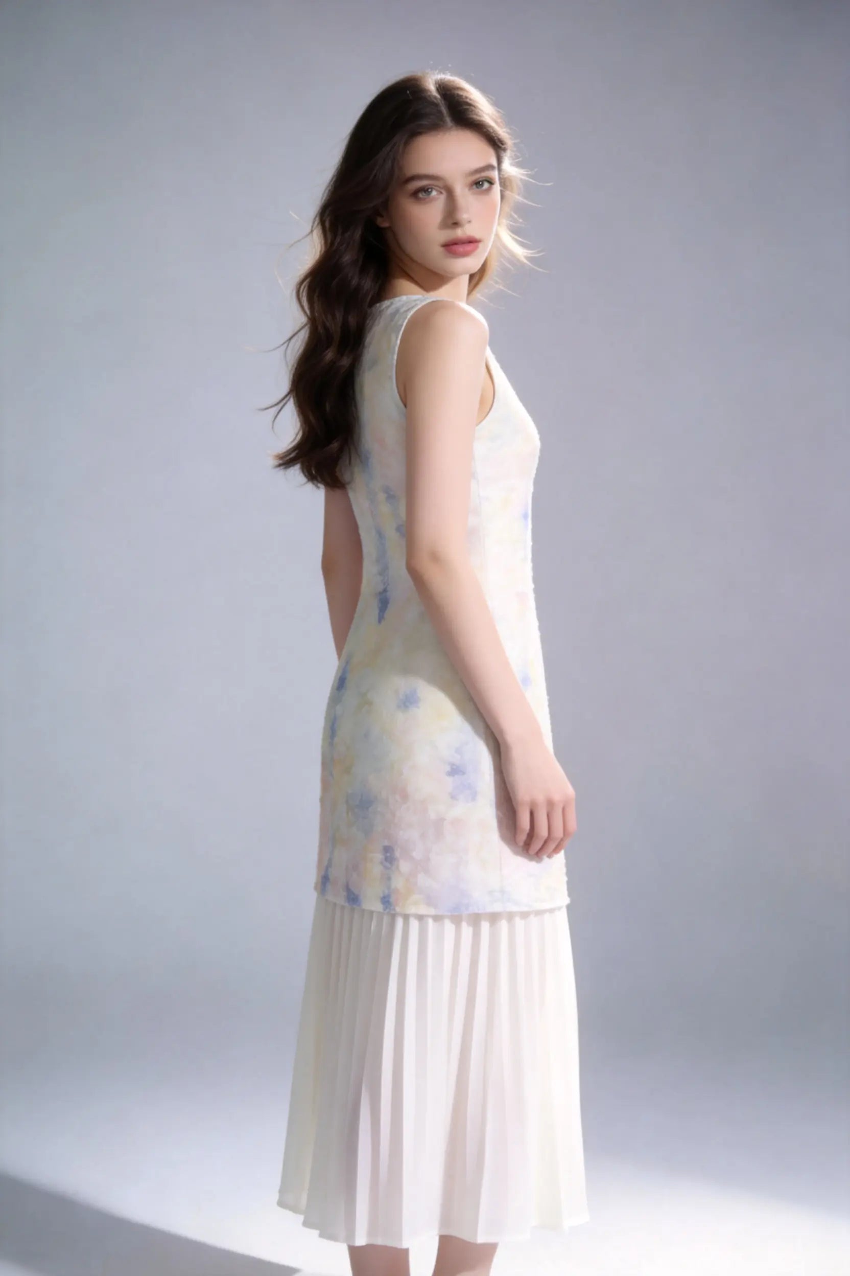 Woman wearing a Watercolor Print Sleeveless Midi Dress with Pleated Hem on a plain background