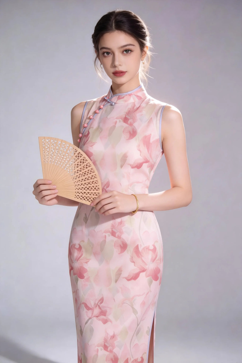 Woman in a elegant pink floral print sleeveless cheongsam dress holding a fan against a gray background