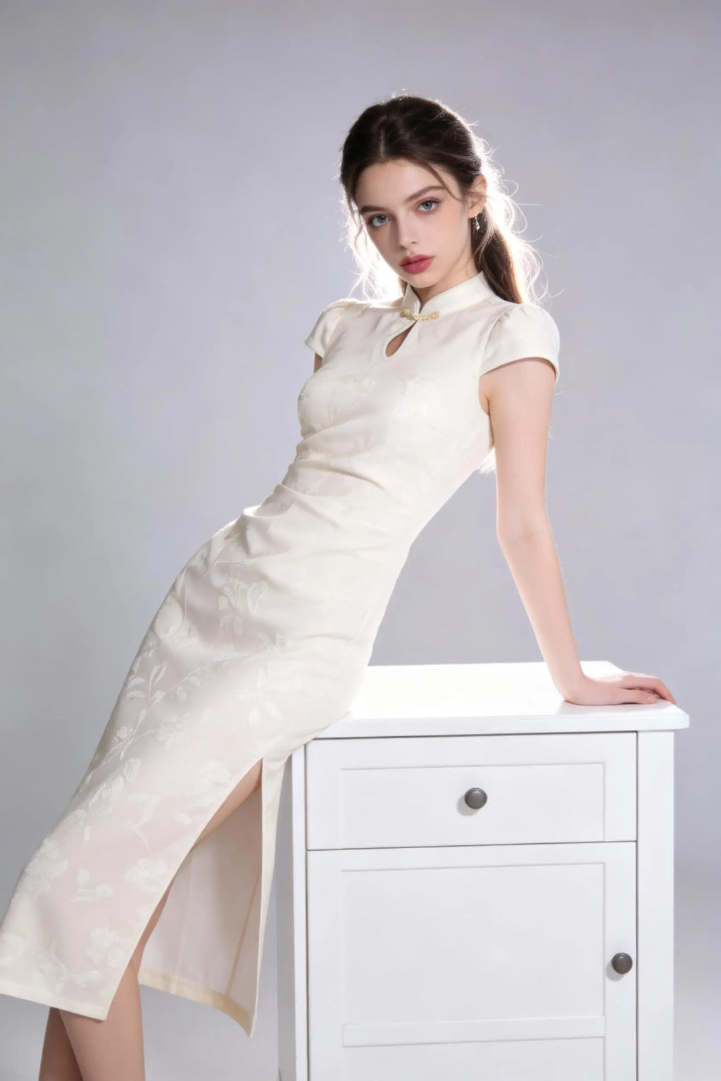 Woman wearing a vintage jacquard qipao dress - elegant mandarin collar cheongsam dress with a high slit on a plain background