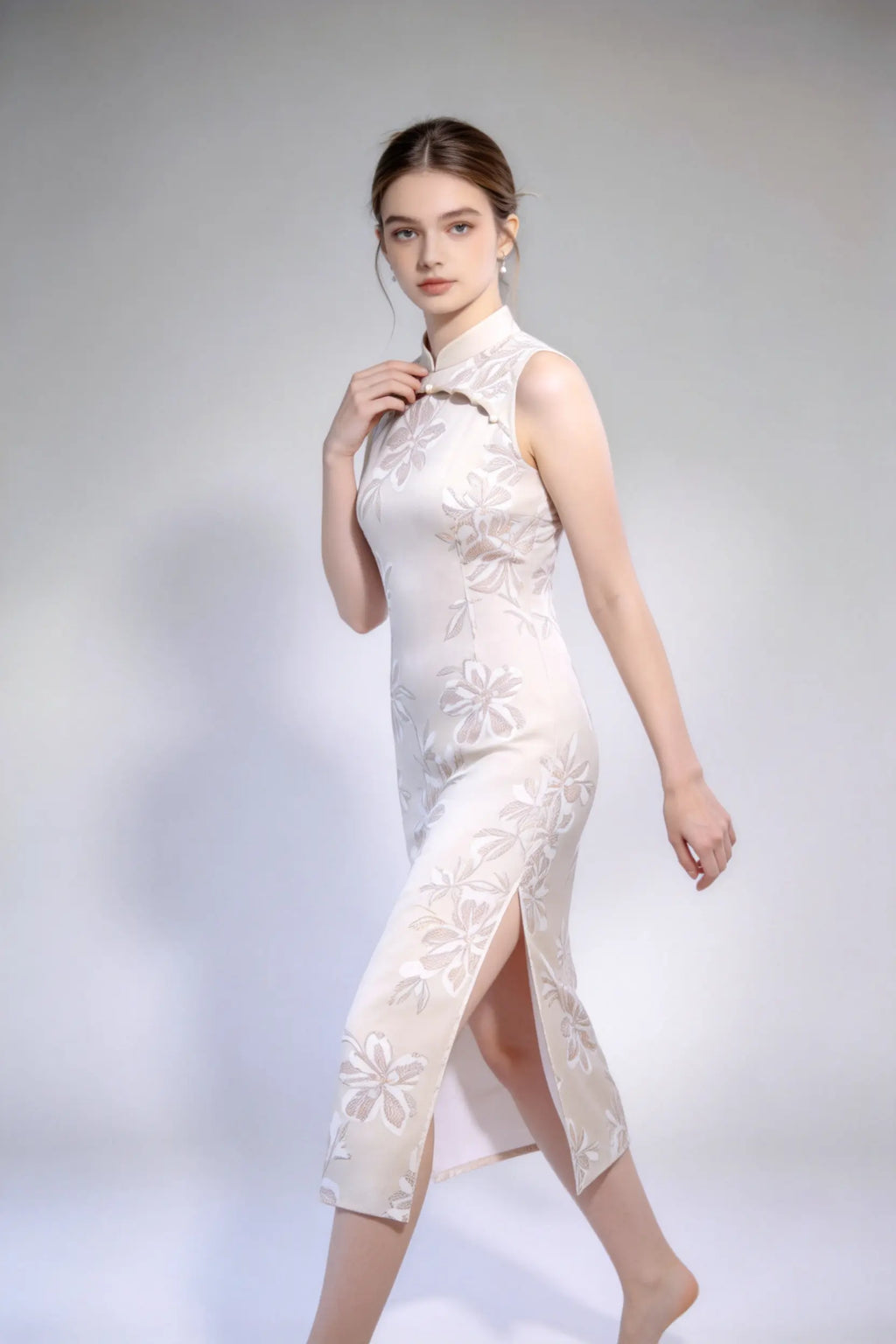 Woman wearing sleeveless floral embroidery cheongsam with cutout frog buttons, double-lined mandarin collar qipao dress against a plain background