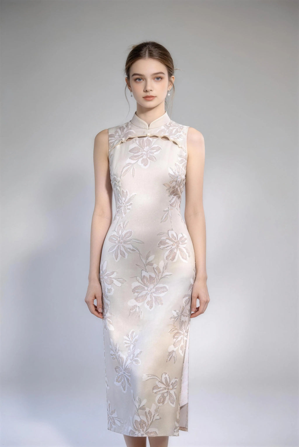 Woman wearing sleeveless floral embroidery cheongsam with cutout frog buttons, double-lined mandarin collar qipao dress against a plain background
