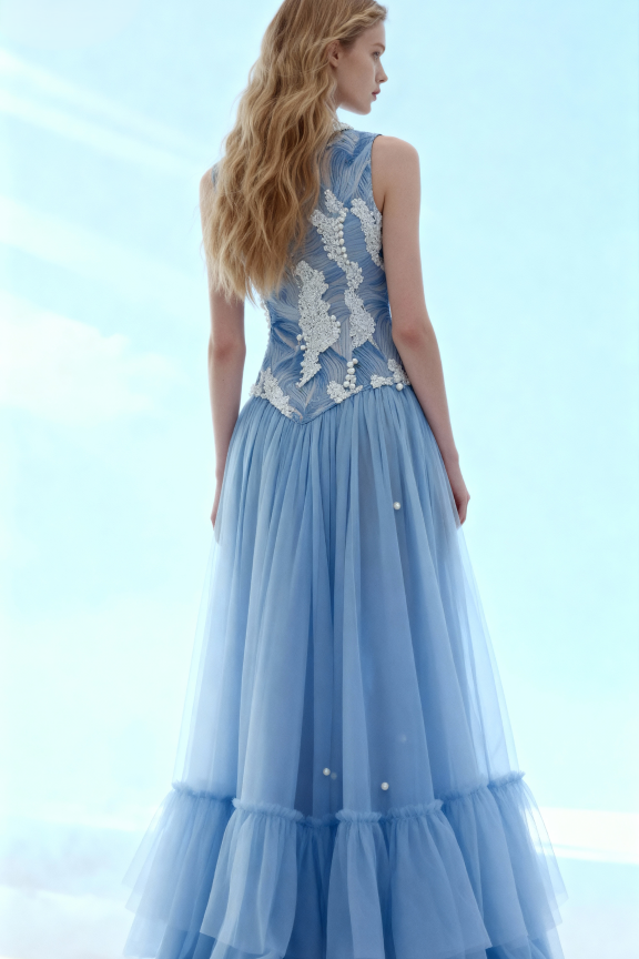 Woman wearing a blue evening gown with lace detailing on a light blue background