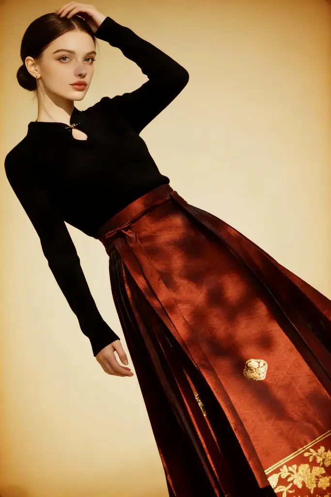 Woman wearing a black top and red skirt with gold accents against a beige background