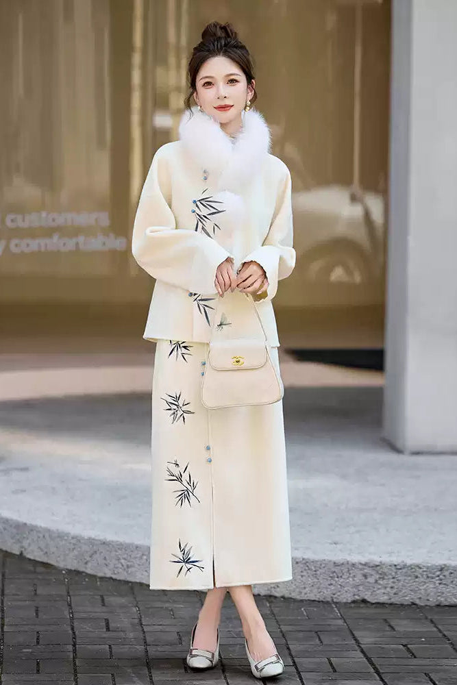 Woman in a Traditional Chinese Bamboo Embroidered Coat & Skirt Set - white, holding a handbag, standing outdoors.
