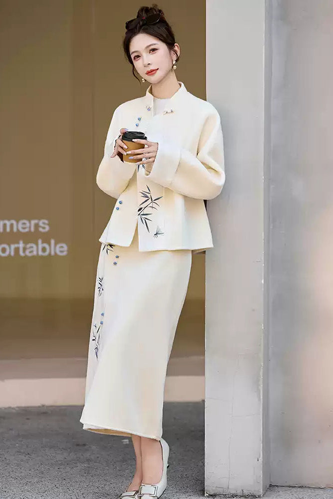 Woman in a Traditional Chinese Bamboo Embroidered Coat & Skirt Set - white, holding a handbag, standing outdoors.